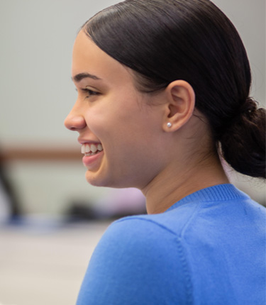 Side profile of a young cancer scientist.