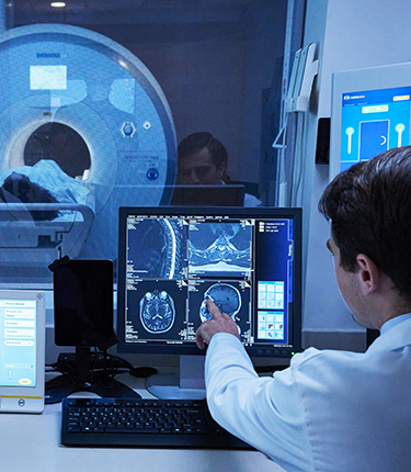 Two specialists using the state-of-the-art MRI Sims machine.