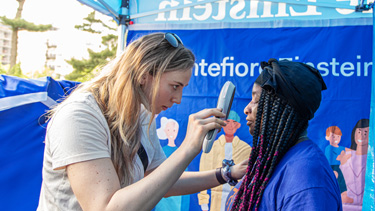 Professional offering a screening check to a patient in the community.