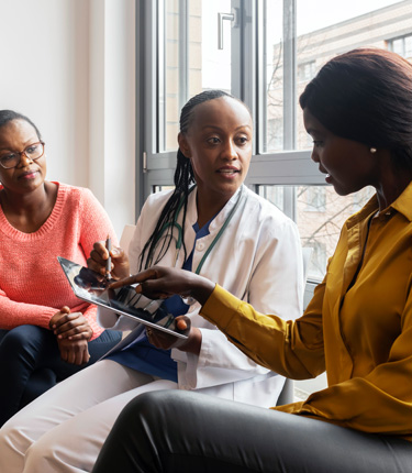 Two patients interacting with a specialist at clinical trials. 