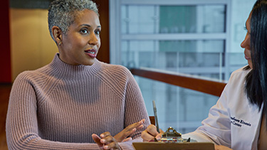 Woman talking to doctor.