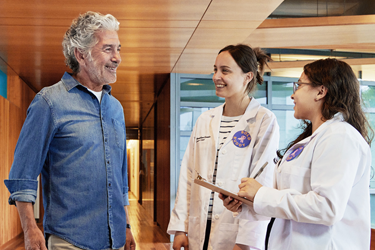 BOLD interns talk with patient.