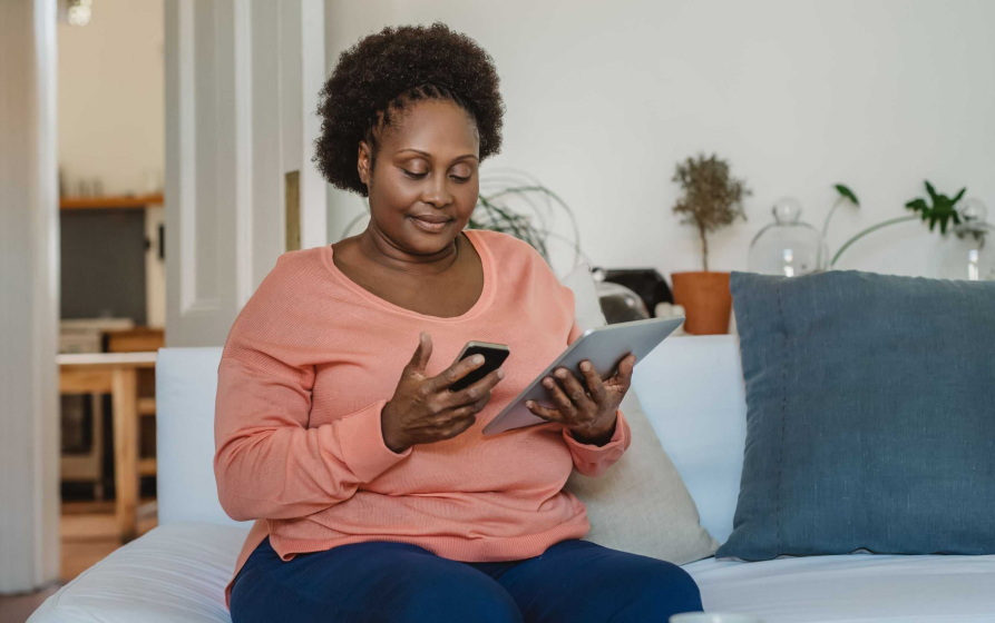 Woman using phone and tablet.